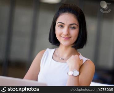 Young busines woman with notebook. Young busines woman sitting and working with notebook