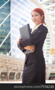 Young business asian woman with document at modern city