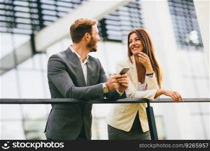 Young business couple looking at the phone