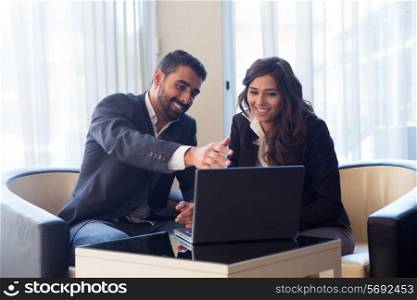 Young business couple meeting with tech devices