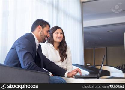 Young business couple meeting with tech devices
