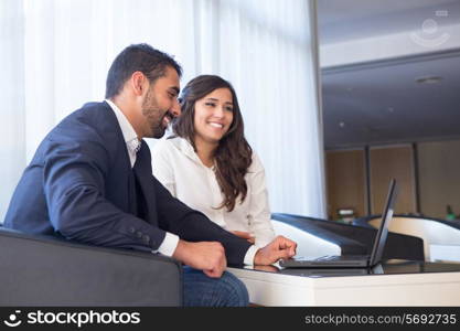 Young business couple meeting with tech devices