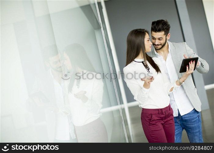Young business couple using tablet in the office