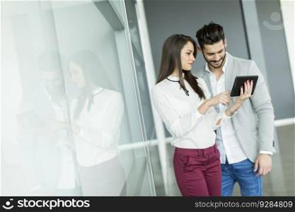 Young business couple using tablet in the office