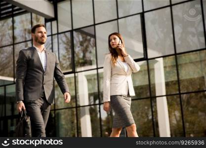 Young business couple walking outdoor near the office building