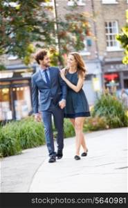 Young Business Couple Walking Through City Park Together