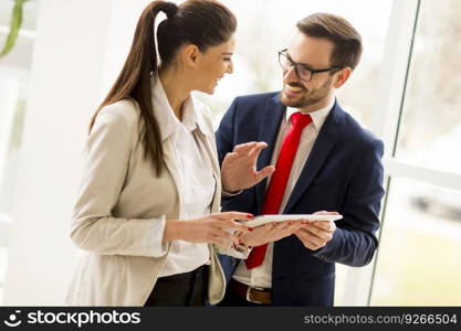 Young business couple with tablet in the office