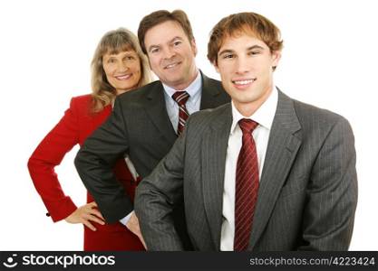 Young business leader with middle aged man and woman. Isolated on white.
