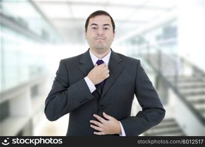 young business man adjusting his tie, isolated on white