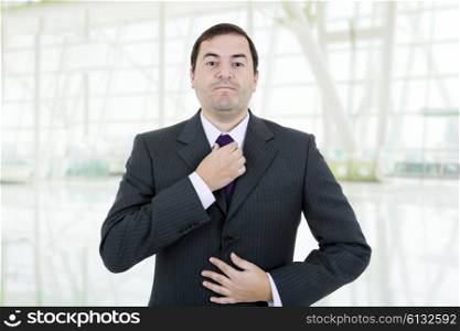 young business man adjusting his tie, isolated on white