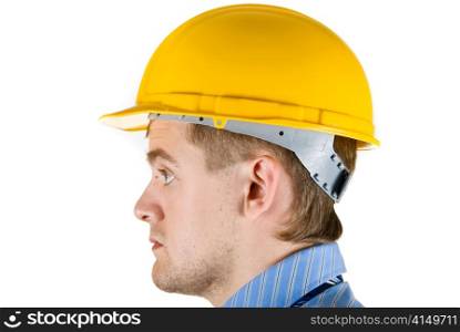Young business man at yellow helmet isolated on white