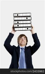 Young business man carrying a bunch of folders