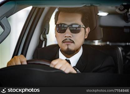 young business man driving a car