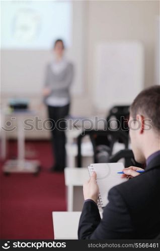 young business man giving presentation and education leassons on seminar event in small bright conference room