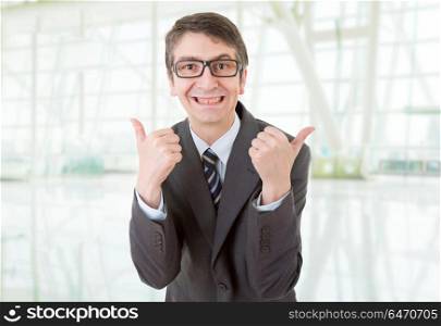 young business man going thumb up, at the office. businessman thumb up