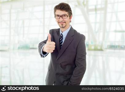 young business man going thumb up, at the office. businessman thumb up