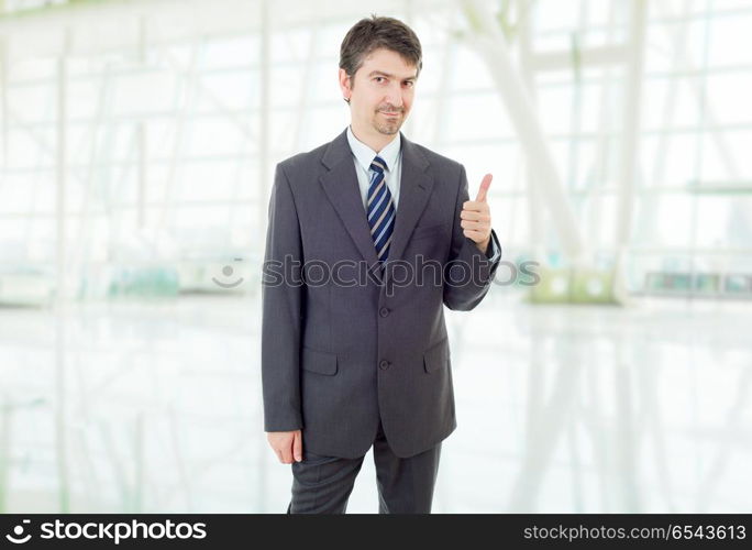 young business man going thumb up, at the office. businessman thumb up