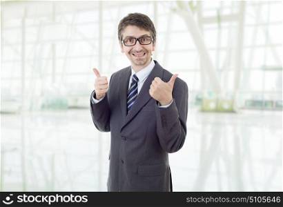 young business man going thumbs up, at the office