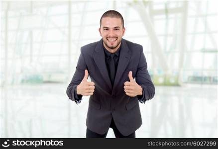 young business man going thumbs up at the office