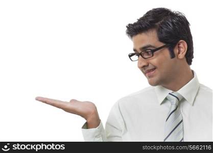 Young business man holding house model over white background
