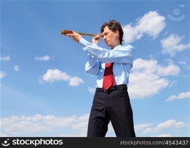 young business man in a blue shirt and red tie against the blue sky looks through a telescope. a symbol of leadership, success and freedom.