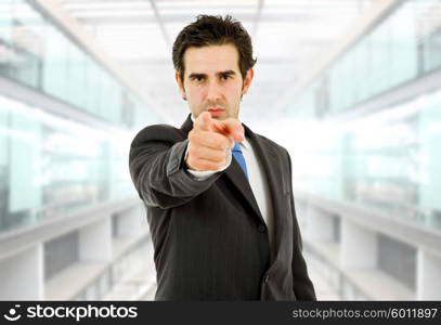 young business man in a suit pointing at the office