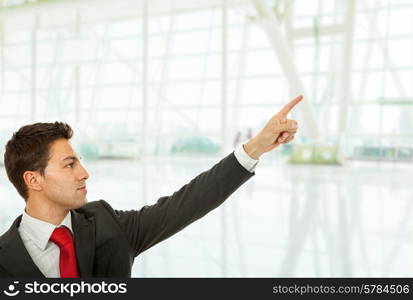 young business man in a suit pointing with his finger