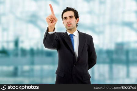 young business man in a suit pointing with his finger