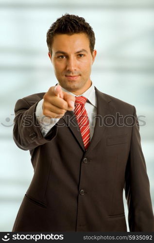 young business man in a suit pointing with his finger