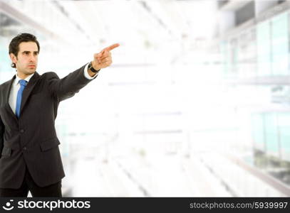 young business man in a suit pointing with his finger