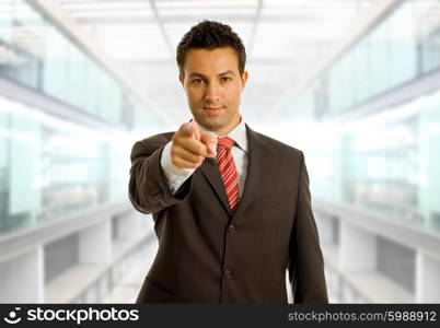 young business man in a suit pointing with his finger