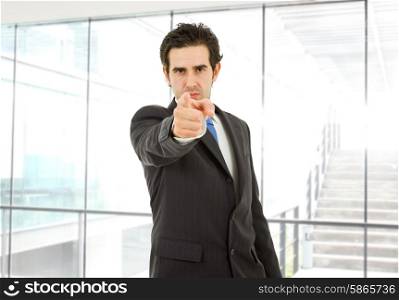 young business man in a suit pointing with his finger at the office