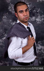 young business man, in front of a dark background