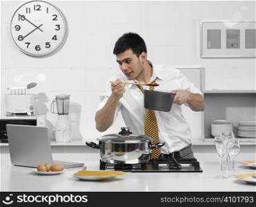young business man in the kitchen with computer