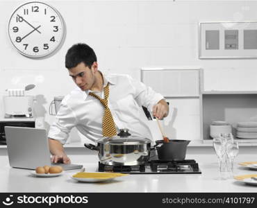 young business man in the kitchen with computer