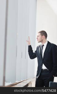 young business man lawyer with laptop alone in big bright conference room