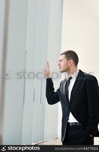 young business man lawyer with laptop alone in big bright conference room