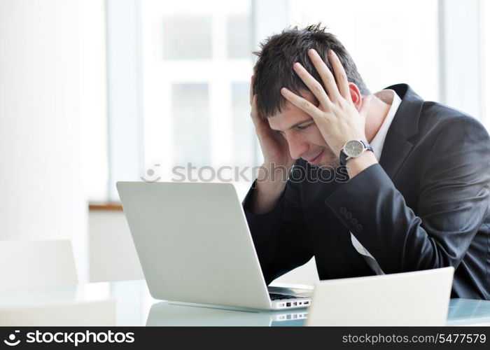 young business man lawyer with laptop alone in big bright conference room