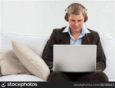 Young business man listening to music and working in his wake