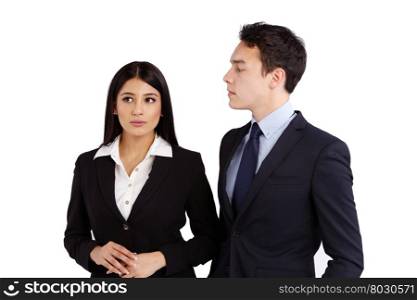 Young business man looking at a business woman disapprovingly. A young Caucasian business man is looking at a business woman disapprovingly. Business woman is ignorant and not making eye contact.