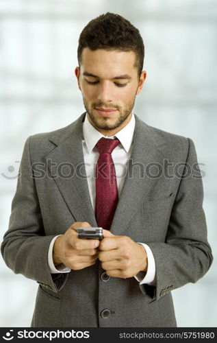 young business man looking to his phone