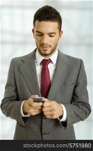 young business man looking to his phone