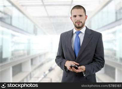 young business man looking to his phone, at the office