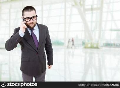 young business man looking to his phone at the office