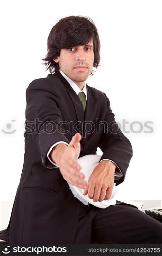 Young business man offering handshake, siting on a desk