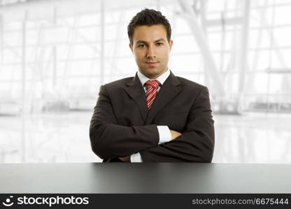 young business man on a desk, isolated on white. business man