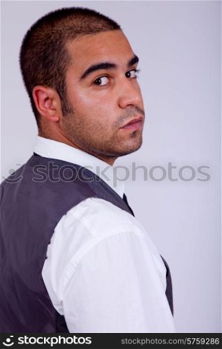 young business man pensive, on a grey background