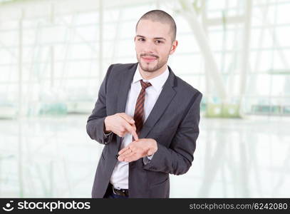 young business man pointing to his hand, at the office