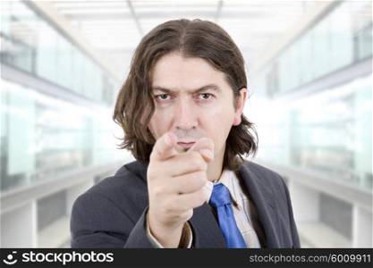 young business man pointing with his finger at the office