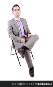 Young business man sitting on a chair, isolated over white